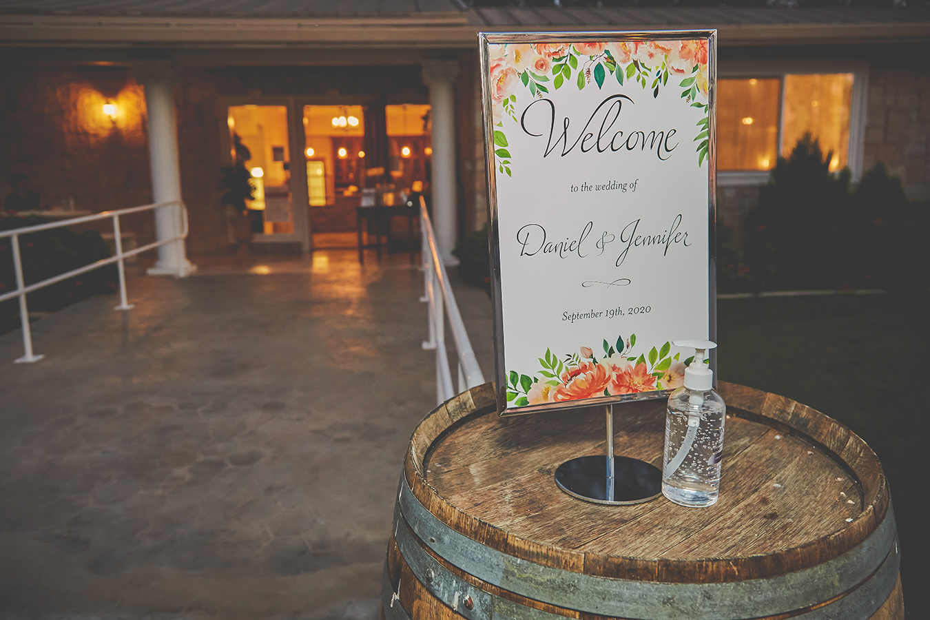 sign on a barrel that says Welcome to the Wedding of Daniel and Jennifer